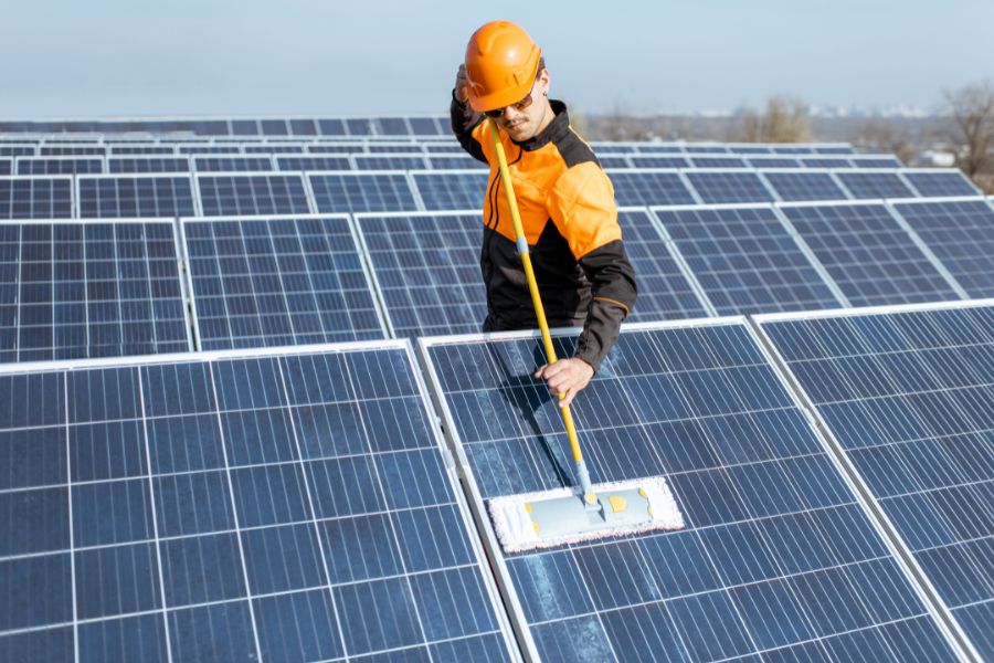 a man cleaning solar panels