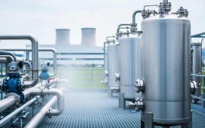 “Stainless-steel water recycling tanks and membrane modules in an industrial facility with clean pipes under bright overcast light.”